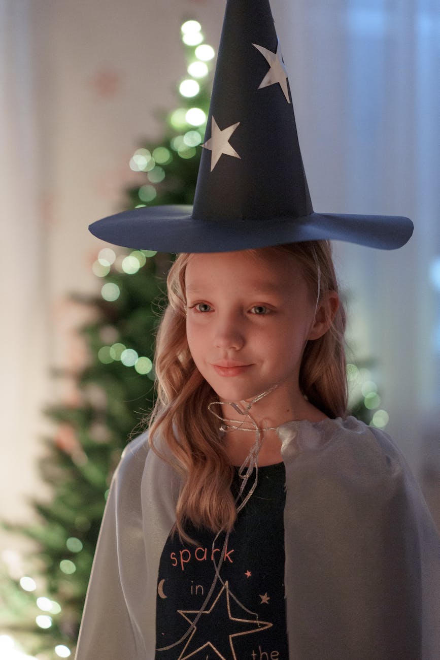 a girl wearing witch hat while looking afar